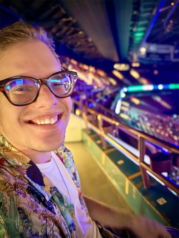 Scott smiling at a concert.
